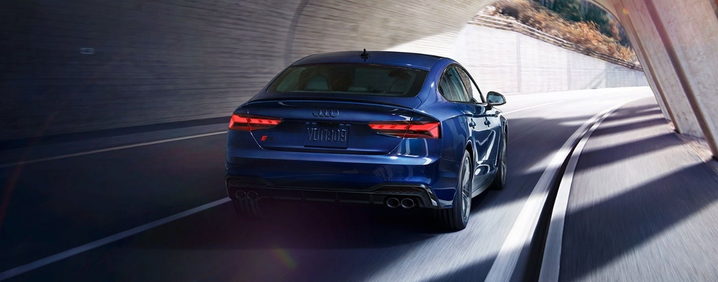 Blue 2025 Audi S5 Sportback driving through a tunnel.